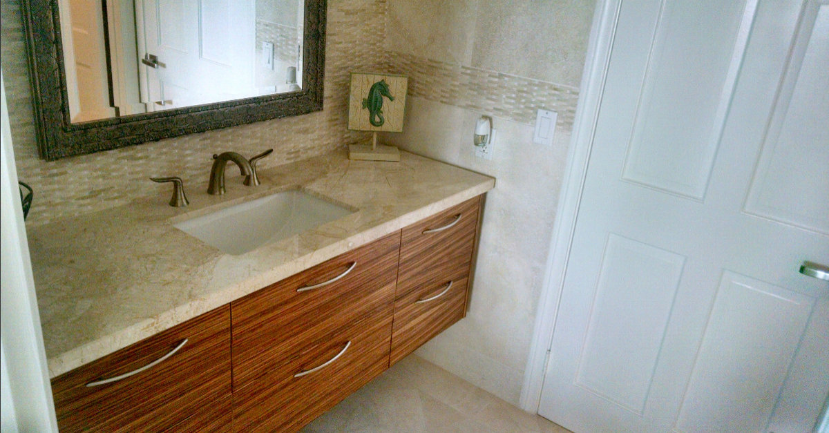 Bathroom remodel with a floating wood vanity and light stone finishes