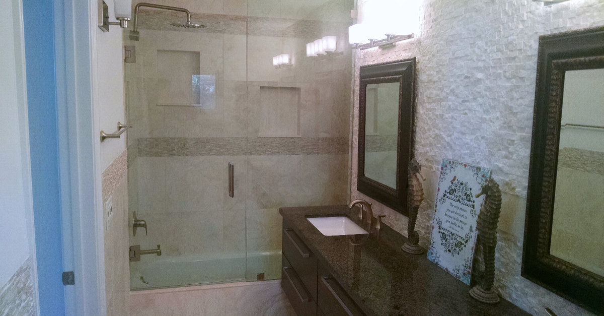 Malibu bathroom remodel with a glass shower and mosaic stone wall